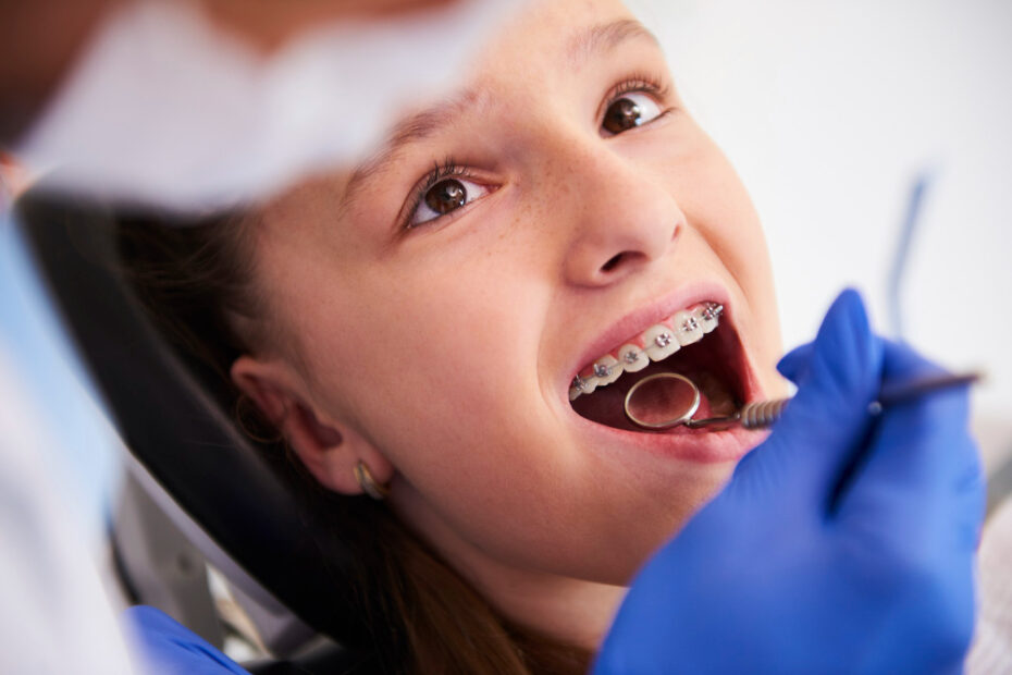 girl with braces during routine dental examination